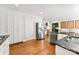 Spacious kitchen featuring hardwood floors, stainless steel appliances, and white cabinetry at 3424 Clydesdale Dr, Gastonia, NC 28056