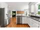 Bright kitchen features stainless appliances, granite counters, white cabinets, and hardwood floors at 3424 Clydesdale Dr, Gastonia, NC 28056