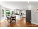 Eat-in kitchen boasts stainless appliances, white cabinets, hardwood floors, and a breakfast nook with large windows at 3424 Clydesdale Dr, Gastonia, NC 28056