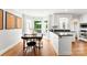 Bright eat-in kitchen with hardwood floors, white cabinetry, stainless appliances, and large windows at 3424 Clydesdale Dr, Gastonia, NC 28056