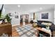 Spacious living room with hardwood floors, neutral walls, modern decor, and connecting dining area at 3424 Clydesdale Dr, Gastonia, NC 28056