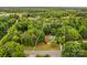 Aerial view of the property showcasing the land size, mature trees, home, and in-ground pool at 366 Faith Rd, Mooresville, NC 28115