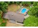 Expansive aerial view of the property, highlighting the in-ground pool, and wooded surroundings at 366 Faith Rd, Mooresville, NC 28115