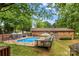 Beautiful backyard with an in-ground pool, patio, and landscaped greenery creating a private outdoor oasis at 366 Faith Rd, Mooresville, NC 28115