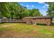 Expansive backyard featuring a large wooden deck, mature trees, and lush green lawn at 366 Faith Rd, Mooresville, NC 28115