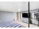 Basement bedroom featuring neutral colors, large screen TV, and clothes hanging rack at 366 Faith Rd, Mooresville, NC 28115