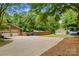 Large driveway with a detached garage, utility building, fenced in backyard, and space for RV parking at 366 Faith Rd, Mooresville, NC 28115