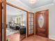 Inviting foyer with a decorative front door, hardwood floors, and an entryway into a comfortable living room at 366 Faith Rd, Mooresville, NC 28115