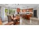 Bright kitchen featuring wood cabinets, stainless steel appliances, granite countertops, and an island, with an adjacent dining area at 366 Faith Rd, Mooresville, NC 28115