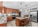 Well-lit kitchen featuring wood cabinets, stainless steel appliances, granite countertops, and an island with barstool seating at 366 Faith Rd, Mooresville, NC 28115