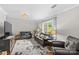Bright living room with hardwood floors, comfortable leather seating, and a floral rug, creating a cozy atmosphere at 366 Faith Rd, Mooresville, NC 28115