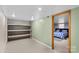 Basement storage room with shelving unit leading into furnished bedroom at 366 Faith Rd, Mooresville, NC 28115