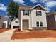 Charming two-story home with stone accents and a separate garage under a bright blue, partly cloudy sky at 4017 Grommet Ct # 3, Matthews, NC 28105