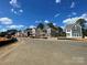 New construction homes line a sunny street, showcasing modern designs and community feel at 4017 Grommet Ct # 3, Matthews, NC 28105