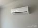A modern air conditioner is mounted on the wall at 4017 Grommet Ct, Matthews, NC 28105
