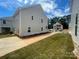 Spacious backyard featuring a long driveway and lawn in a neighborhood with new construction at 4017 Grommet Ct, Matthews, NC 28105