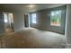 A bedroom with neutral walls shows windows providing natural light and view of the outside at 4017 Grommet Ct, Matthews, NC 28105