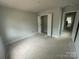 Unfinished bedroom featuring a closet and an open doorway at 4017 Grommet Ct, Matthews, NC 28105
