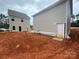 New construction home featuring gray siding, white trim, and a private entrance, awaiting landscaping at 4017 Grommet Ct, Matthews, NC 28105