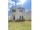 Charming two-story home featuring stone accents and a beautifully landscaped front yard on a sunny day at 4017 Grommet Ct, Matthews, NC 28105
