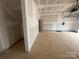 Spacious two-car garage interior featuring unfinished walls, concrete floor, and visible garage door hardware at 4017 Grommet Ct, Matthews, NC 28105
