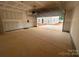 Unfinished two-car garage interior showcasing unfinished walls, concrete flooring, and an open garage door at 4017 Grommet Ct, Matthews, NC 28105