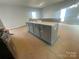 Kitchen with a central island featuring gray cabinetry and lots of storage at 4017 Grommet Ct, Matthews, NC 28105