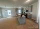 Spacious kitchen featuring a central island, gray cabinets and modern appliances at 4017 Grommet Ct, Matthews, NC 28105