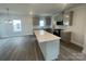 Modern kitchen features a large island, stainless steel appliances, and gray cabinets at 4017 Grommet Ct, Matthews, NC 28105