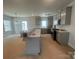 Unfinished kitchen with an island, gray cabinets, and lots of natural light at 4017 Grommet Ct, Matthews, NC 28105