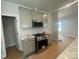 Kitchen area with stainless steel appliances and gray cabinetry at 4017 Grommet Ct, Matthews, NC 28105