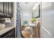 Quaint bathroom with a pedestal sink, black cabinets, and decorative shower curtain at 404 N Laurel St, Lincolnton, NC 28092