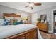 Comfortable bedroom with a carved wood bed frame, layered pillows, and a bright window view at 404 N Laurel St, Lincolnton, NC 28092