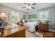 Bright bedroom with an antique bed, multiple dressers, hardwood floors, and decorative accents at 404 N Laurel St, Lincolnton, NC 28092