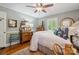 Bright bedroom featuring hardwood floors, soft lighting, and vintage furnishings at 404 N Laurel St, Lincolnton, NC 28092
