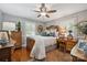 Well-lit bedroom with two dressers, warm wooden desk, and vintage wooden bed frame at 404 N Laurel St, Lincolnton, NC 28092