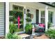 Charming porch featuring a vibrant green door, seasonal decor, and comfortable seating offering a welcoming entrance at 404 N Laurel St, Lincolnton, NC 28092
