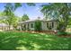 Quaint home exterior featuring a well-manicured lawn, mature trees and a charming porch swing adding to the curb appeal at 404 N Laurel St, Lincolnton, NC 28092
