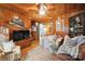 Cozy living room with wood paneling, ceiling fan, and comfortable seating arrangement creating a warm ambiance at 404 N Laurel St, Lincolnton, NC 28092
