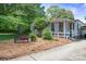 A charming side yard featuring a quaint bench, lush greenery, and a cozy, inviting atmosphere with natural landscaping at 404 N Laurel St, Lincolnton, NC 28092