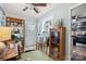 Cozy sunroom with vintage furniture and decor, adjacent to kitchen and doorway to exterior at 404 N Laurel St, Lincolnton, NC 28092