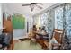Charming sitting room with rocking chairs, a rustic desk, and vintage decor accents at 404 N Laurel St, Lincolnton, NC 28092