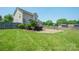 Expansive backyard with lush grass, a patio, fire pit, storage shed, and fenced perimeter at 4301 Windjammer Sw Ct, Concord, NC 28027