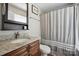 The bathroom offers granite countertops, shower and updated features at 4301 Windjammer Sw Ct, Concord, NC 28027