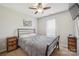 Bedroom with a metal frame bed, ceiling fan, and neutral-toned decor at 4301 Windjammer Sw Ct, Concord, NC 28027