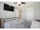 This bedroom features a ceiling fan, TV and ample closet space at 4301 Windjammer Sw Ct, Concord, NC 28027