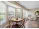 Cozy dining area with natural light, wooden table, and a view of the backyard at 4301 Windjammer Sw Ct, Concord, NC 28027