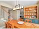 Dining room with a wooden table and blue display cabinet, open to the stairs and living room at 4301 Windjammer Sw Ct, Concord, NC 28027