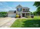 Charming two-story home with brick and siding, landscaped yard, and an attached two-car garage at 4301 Windjammer Sw Ct, Concord, NC 28027