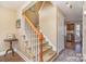 Inviting foyer with a staircase, hardwood floors, and neutral walls, leading to the kitchen at 4301 Windjammer Sw Ct, Concord, NC 28027